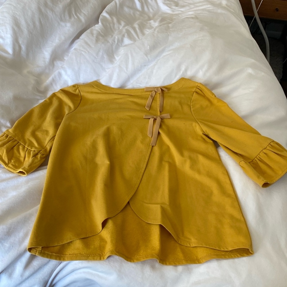 Mustard 3/4 sleeve blouse with cute ties in the back…. Make it yours today